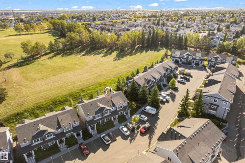 Townhouse exterior with grey siding and dark shingle roofing - #22 4205 30 St Nw, Edmonton, AB 