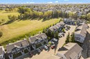 Townhouse exterior with grey siding and dark shingle roofing - #22 4205 30 St Nw, Edmonton, AB 
