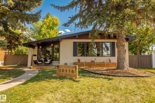 Mid-century modern residence featuring a light-colored brick exterior, dark-trimmed windows, and a covered entry porch - 10316 42 Street Nw, Edmonton, AB 