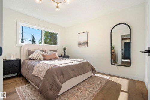 Recessed window with white trim, wood-finish flooring, and a contemporary ceiling light fixture - 10316 42 Street Nw, Edmonton, AB 