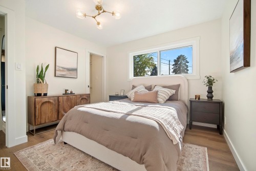 Wood-finish flooring, white walls, and a modern ceiling light fixture - 10316 42 Street Nw, Edmonton, AB 