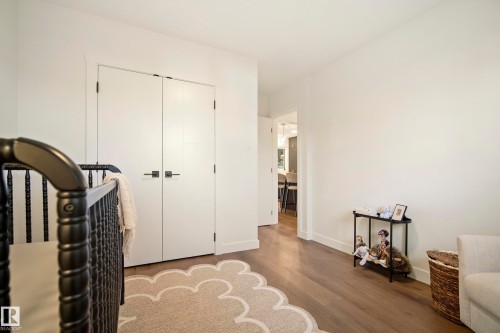 Wood-finish flooring throughout, bright white walls, and a recessed doorway - 10316 42 Street Nw, Edmonton, AB 