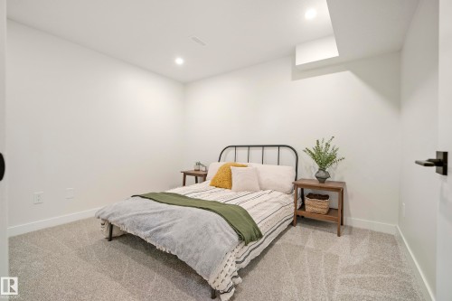 Neutral wall color, recessed ceiling lighting, light-toned carpeting, and a black lever door handle - 10316 42 Street Nw, Edmonton, AB 