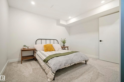 Plush carpeting, recessed lighting, and a modern interior door with matte black hardware - 10316 42 Street Nw, Edmonton, AB 