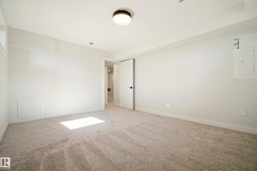 Recessed window, neutral wall paint, light-toned carpet, and a flush mount ceiling light - 10316 42 Street Nw, Edmonton, AB 
