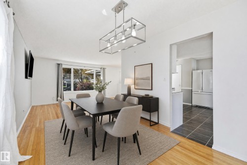 Hardwood flooring, recessed lighting, and a modern rectangular chandelier - 74 Aspen Crescent, St. Albert, AB 
