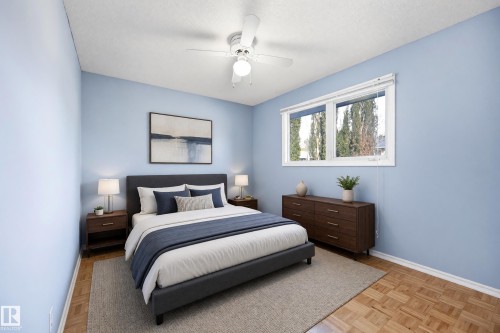Recessed window with white blinds, wood-finish flooring, and white ceiling fan with integrated lighting - 74 Aspen Crescent, St. Albert, AB 
