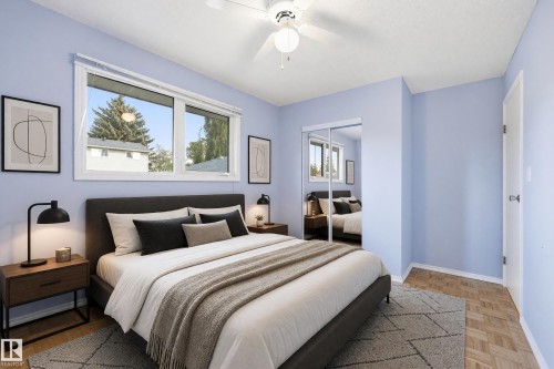 Large window with white blinds, wood-finish flooring, and mirrored closet doors - 74 Aspen Crescent, St. Albert, AB 