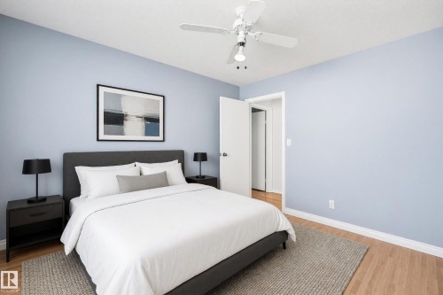 Light wood-finish flooring with a ceiling fan and overhead lighting - 74 Aspen Crescent, St. Albert, AB 