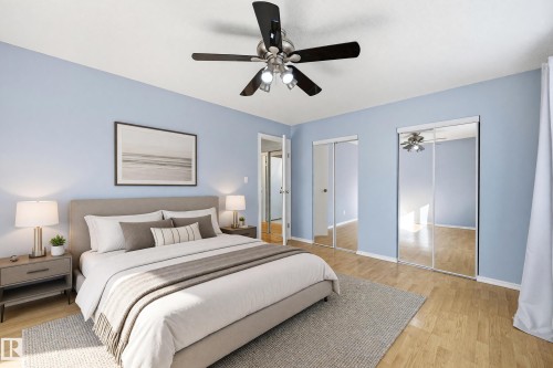 Wood-finish flooring, ceiling fan with integrated lighting, and mirrored sliding closet doors - 74 Aspen Crescent, St. Albert, AB 