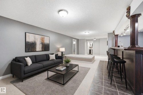 Integrated wet bar with track lighting, recessed ceiling lights, and two-tone wall finishes - 74 Aspen Crescent, St. Albert, AB 