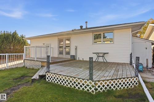Expansive wood deck with white lattice skirting and metal balusters - 74 Aspen Crescent, St. Albert, AB 