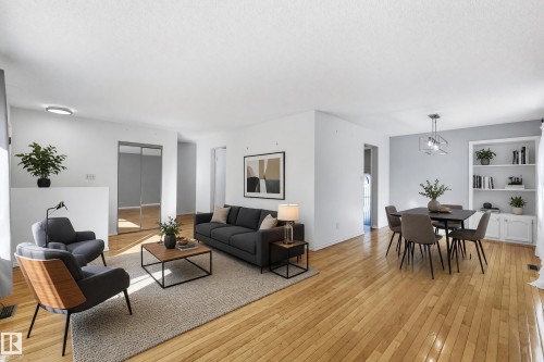 Hardwood flooring, recessed lighting, built-in shelving, mirrored closet doors, and a modern dining light fixture - 74 Aspen Crescent, St. Albert, AB 