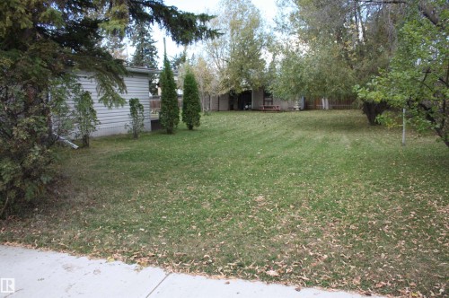 Expansive grassy yard with mature trees - 5012 49 Ave, Radway, AB 