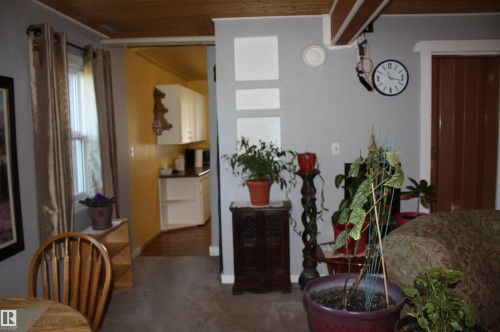 Wood-plank ceiling, exposed structural beam, and crisp wall finishes - 5012 49 Ave, Radway, AB 