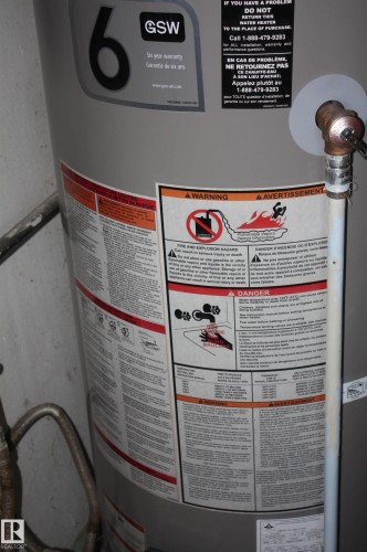 GSW brand water heater featuring a cylindrical metal tank and vertical plumbing connections - 5012 49 Ave, Radway, AB 