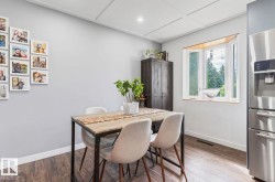 Wood-finish flooring with a light gray wall color, tray ceiling with recessed lighting, and a bay window - 