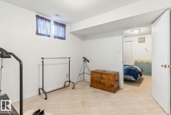 Carpeted room with a drop ceiling and two windows - 