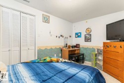Louvered bi-fold closet doors, textured wall finishes, and ceiling-mounted light fixtures - 