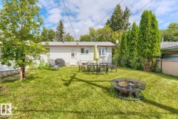Expansive lawn with mature trees and established privacy landscaping - 