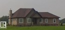 Stucco exterior with stone accents and a prominent chimney - 57314 Rge Road 255, Rural Sturgeon County, AB 