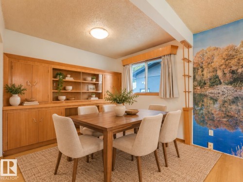 Built-in cabinetry with open shelving and closed storage, wood-finish flooring, and a flush-mount ceiling light - 5904 94 Avenue Nw, Edmonton, AB 