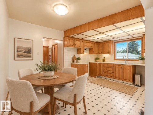 Kitchen featuring extensive wood cabinetry, white tiled backsplash, under-cabinet lighting, and a window with a stainless steel sink - 5904 94 Avenue Nw, Edmonton, AB 