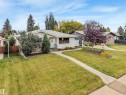 Well-manicured lawn with a concrete walkway, mature trees, and shrubs - 5904 94 Avenue Nw, Edmonton, AB 