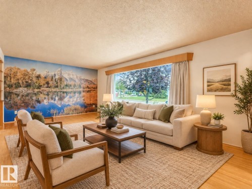 Expansive living area with wood-finish flooring, a large picture window, and a decorative wall mural - 5904 94 Avenue Nw, Edmonton, AB 