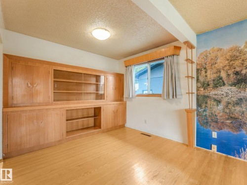 Built-in wood cabinetry with glass-front display shelves - 5904 94 Avenue Nw, Edmonton, AB 