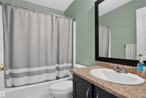 Bathroom featuring a built-in vanity with an oval sink and a framed mirror - 1519 104 Street Nw, Edmonton, AB 