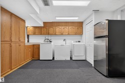 Extensive built-in wood cabinetry, light countertops, and durable flooring create a functional space - 