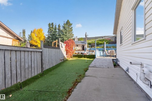 White siding exterior with a concrete pathway and artificial turf - 1519 104 Street Nw, Edmonton, AB 