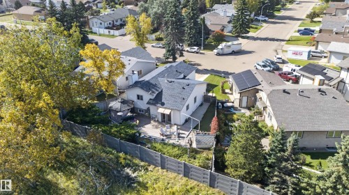 Sloping rear yard, multi-level home, paved patio, and mature landscaping - 1519 104 Street Nw, Edmonton, AB 
