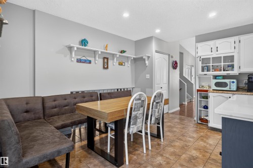 Kitchen space featuring white cabinetry, a built-in banquette, tile flooring, and recessed lighting - 1519 104 Street Nw, Edmonton, AB 