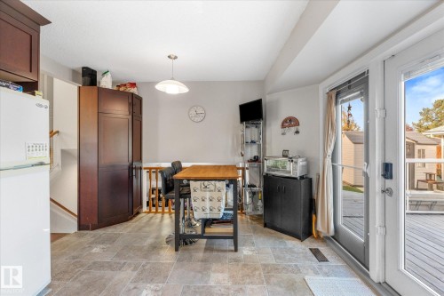 Tile flooring, built-in pantry cabinetry, pendant lighting, and direct outdoor access - 4103 44 Avenue, Stony Plain, AB 