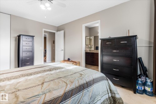 Carpeted flooring, ceiling fan with integrated lighting, and neutral wall tones - 4103 44 Avenue, Stony Plain, AB 
