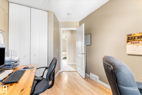 Wood-finish flooring with a neutral wall color and white trim - 4103 44 Avenue, Stony Plain, AB 