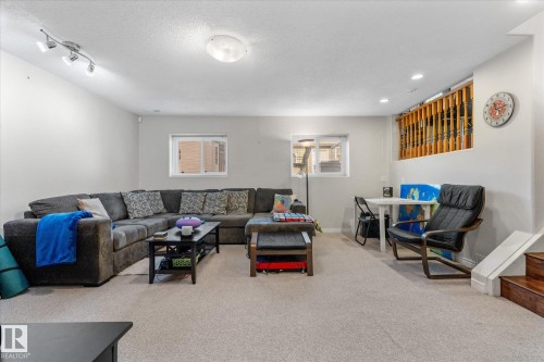 Recessed lighting, track lighting, two windows, carpet flooring, and wood stair treads - 4103 44 Avenue, Stony Plain, AB 