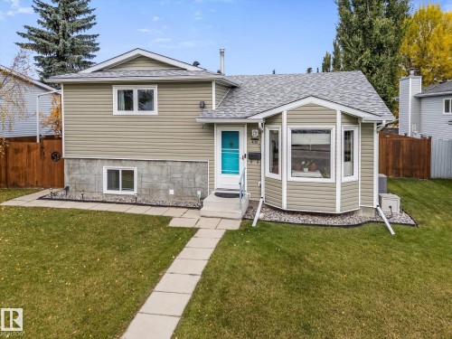 Exterior featuring siding, a front bay window, and a light blue entry door - 4103 44 Avenue, Stony Plain, AB 