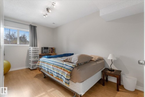 Light wood-finish flooring, white walls, recessed window, and track lighting - 4103 44 Avenue, Stony Plain, AB 