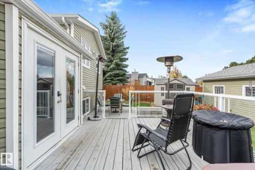 Deck with light gray wood-finish planks, white railings, and clear panel inserts - 4103 44 Avenue, Stony Plain, AB 