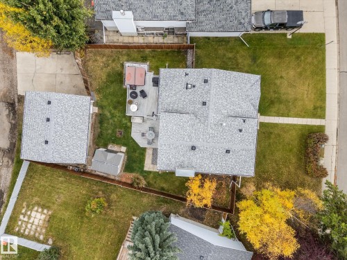 Spacious property featuring a main residence, detached garage, and an expansive backyard with a multi-level deck and shed - 4103 44 Avenue, Stony Plain, AB 