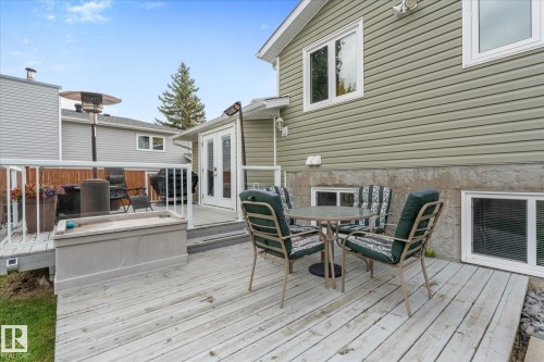 Expansive wood deck with white railings and clear panels - 4103 44 Avenue, Stony Plain, AB 