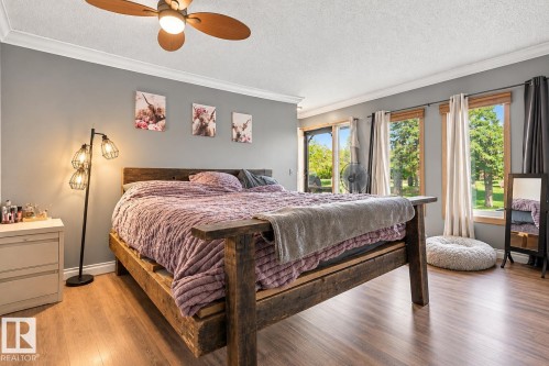 Wood-finish flooring with crown molding and a ceiling fan - 62202 Rr 444, Rural Bonnyville M.D., AB 