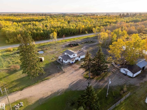 Spacious property featuring a white residence, a detached garage, and a large surrounding land area - 62202 Rr 444, Rural Bonnyville M.D., AB 