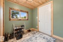 Wood-finish flooring with coordinating wood trim, a paneled door, and a horizontal window with a distressed wood-finish frame - 62202 Rr 444, Rural Bonnyville M.D., AB 
