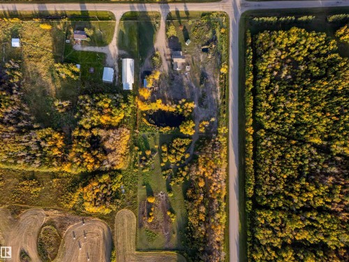 Expansive wooded acreage featuring multiple buildings, a pond, and direct road access - 62202 Rr 444, Rural Bonnyville M.D., AB 