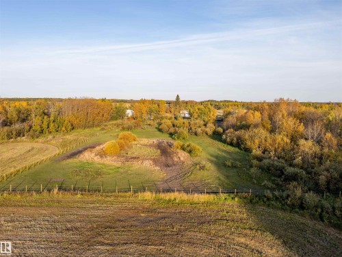 Expansive rural landscape featuring mature trees with autumn foliage, open fields, and fencing - 62202 Rr 444, Rural Bonnyville M.D., AB 