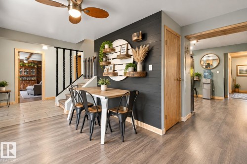 Wood-finish flooring throughout, complemented by a decorative shiplap accent wall - 62202 Rr 444, Rural Bonnyville M.D., AB 